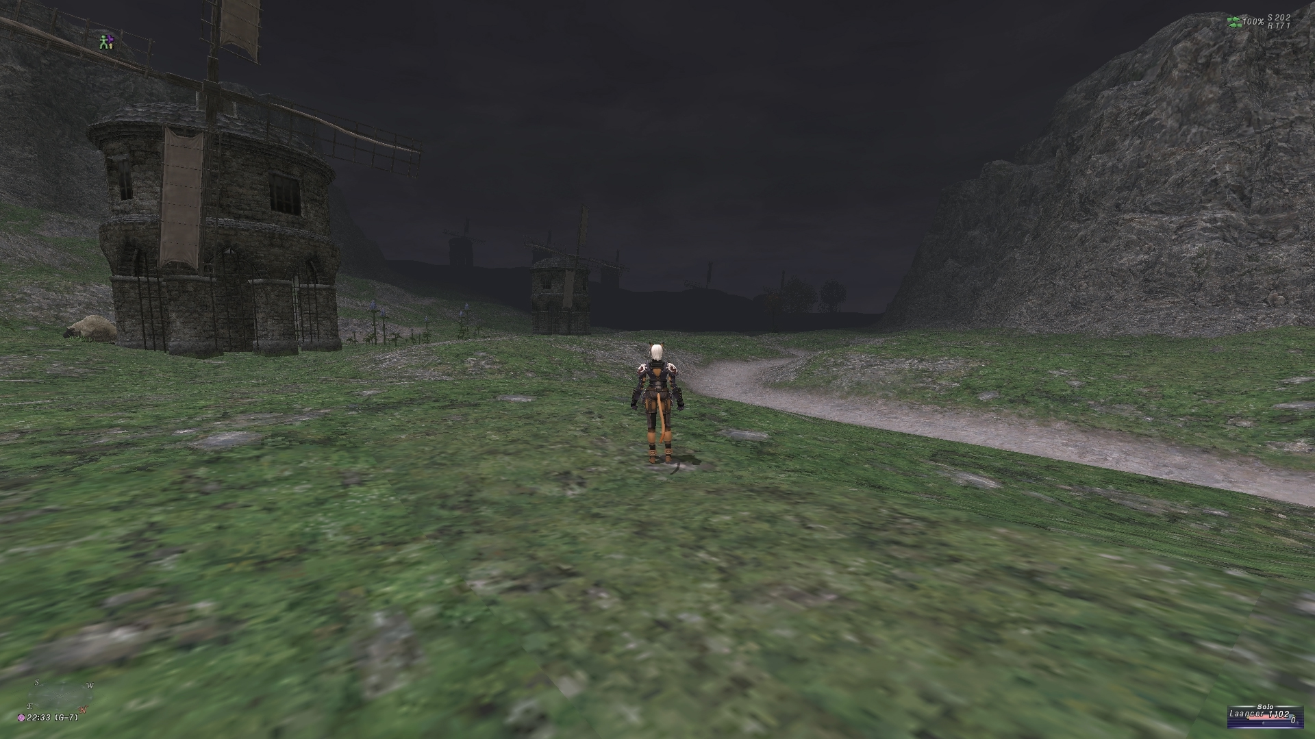 videogame character stands with back to camera. Decrepit windmills occupy the midground and background.
